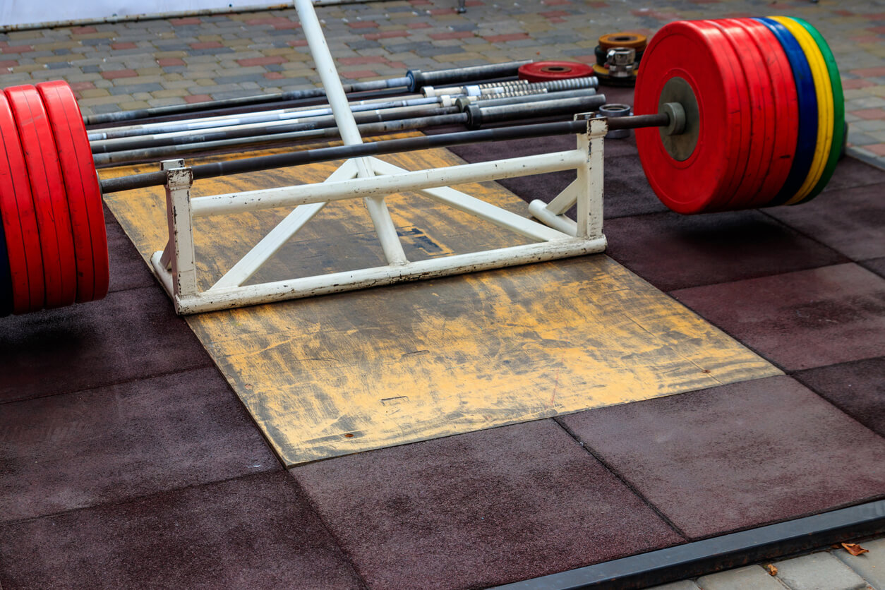- Deadlift station with bar and weights, a fundamental exercise for building strength and muscle in the lower body.