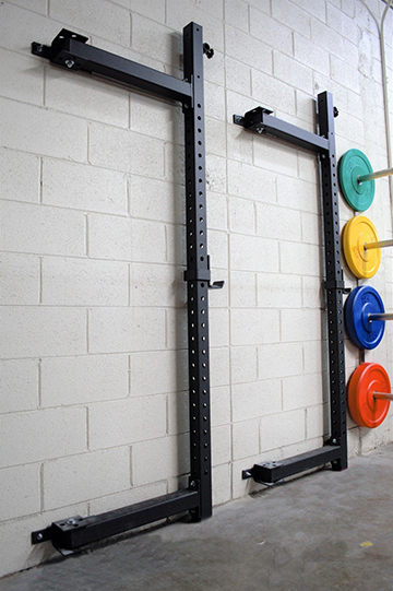 - Foldable squat rack with hanging weight bars, providing a versatile option for strength training exercises