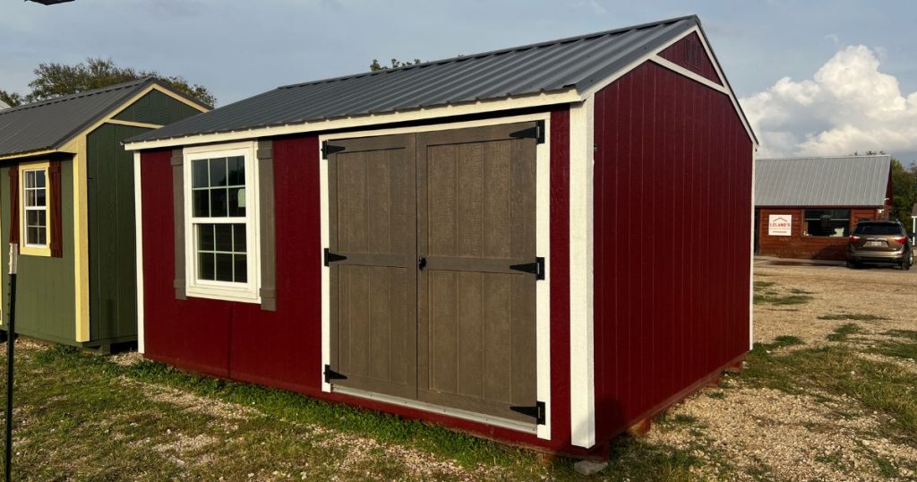 - burgundy chalet shed with metal roof