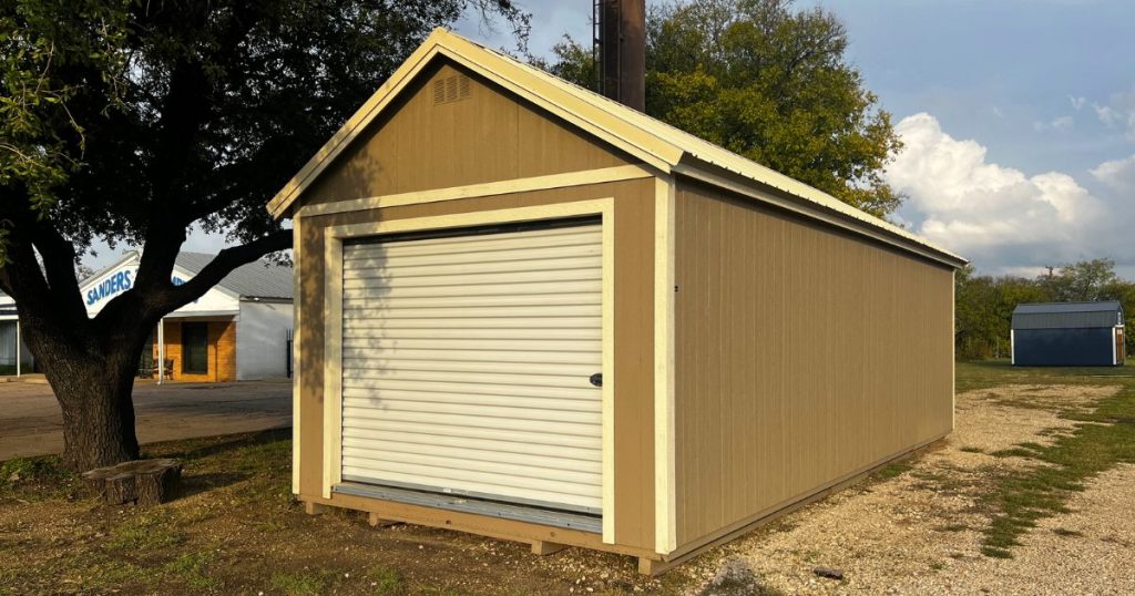 - lelands tan garage with white roll up door