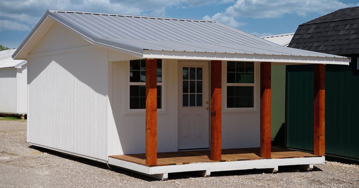 - white cottage shed with 4 wooden columns on porch