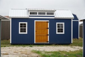  -  - For sale: A blue shed with a wooden door, available at a nearby shed store.