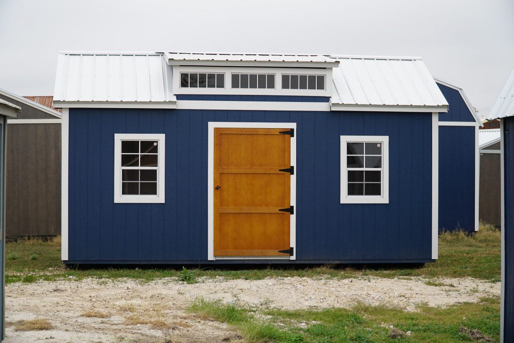 A for sale blue shed with a wooden door.