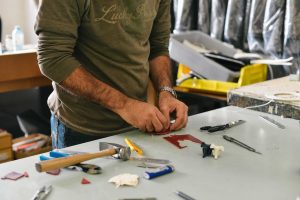  -  - A man working with tools on a table at a shed store near me.