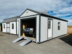  -  - A car is parked next to a storage shed available for sale.