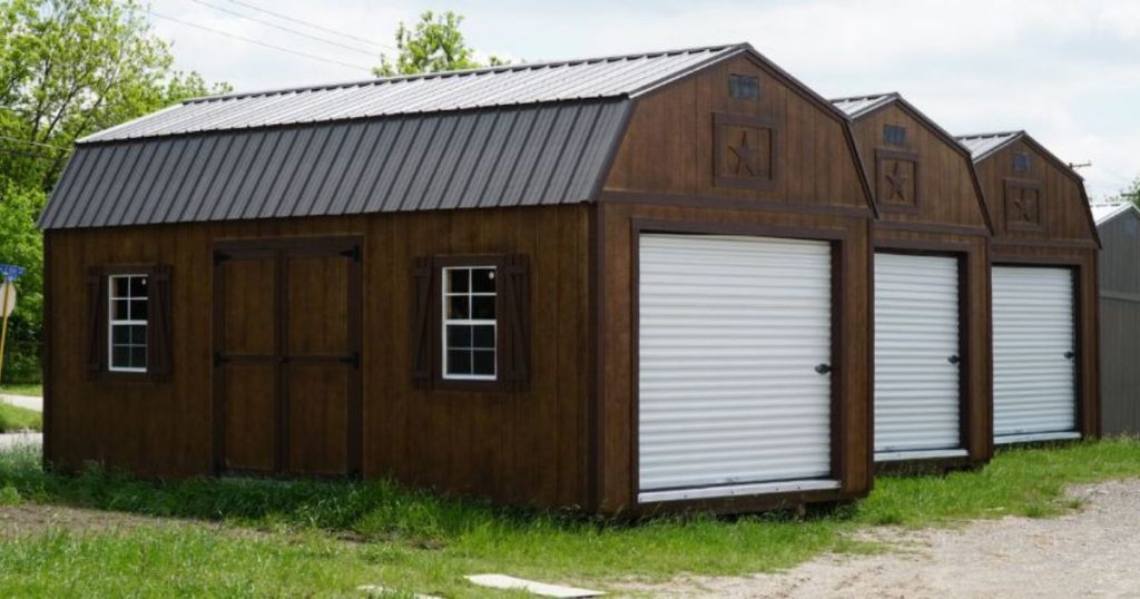 three brown garage sheds with white roll up doors