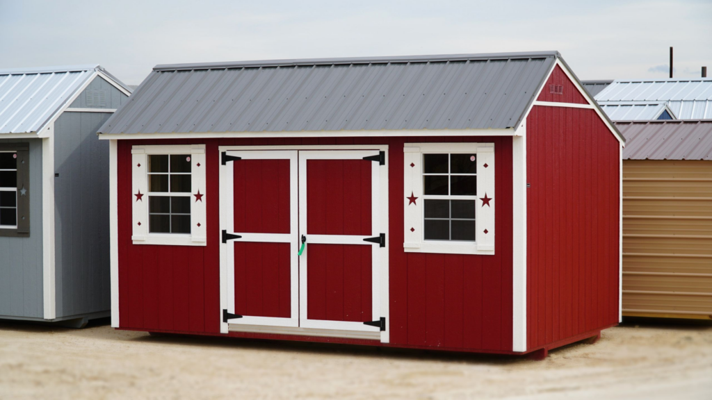 Eye-catching red garden shed with grey metal roof and double doors, providing ample storage and enhancing the look of your outdoor space.