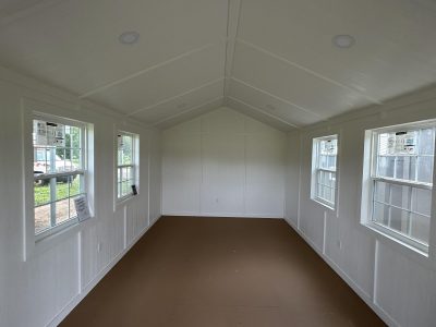 A minimalistic 12x24 Diamond Cabinette Shed with white walls and large windows.