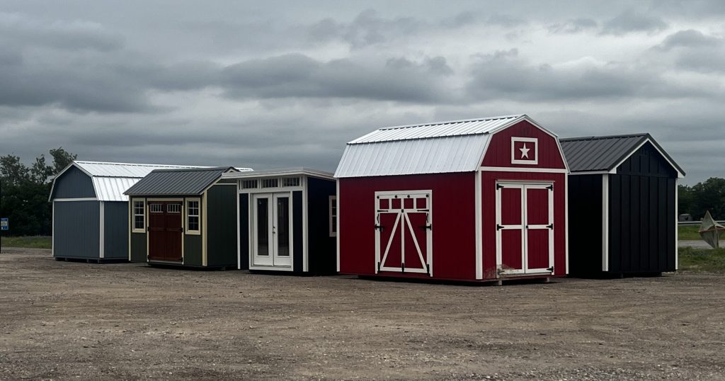 a group sheds for sale on a shed dealership lot