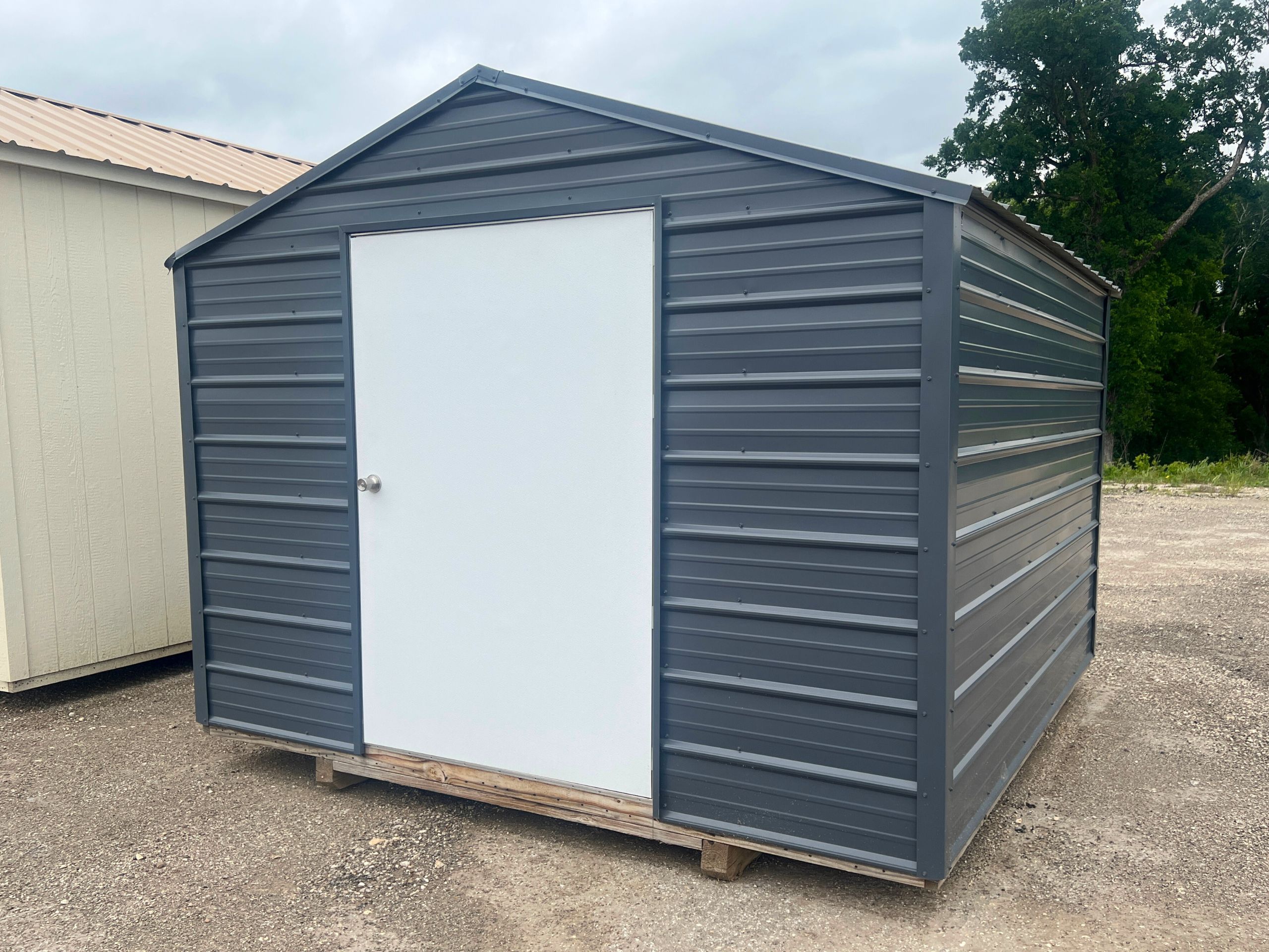 grey metal shed with white entry door