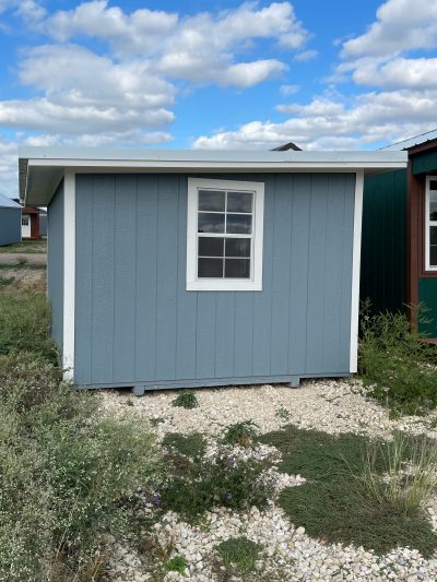 A 10x12 Studio Shed with a blue roof and a small window, available for sale near me.