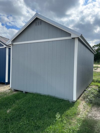 Two 12x20 Chalet Sheds for sale in a grassy area.