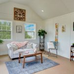 A living room with a white couch and tv. - LELAND'S SHEDS - A living room with a white couch and tv.
