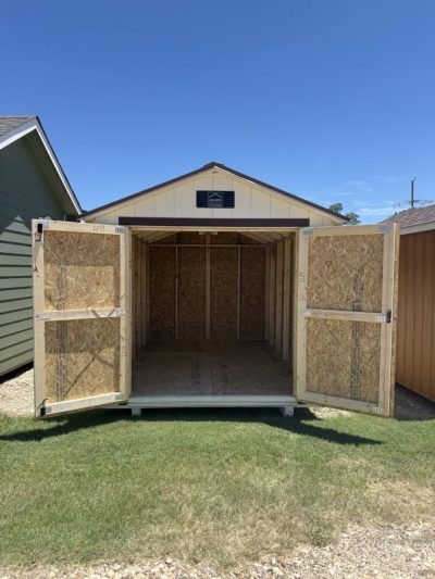 IMG_3871 - LELAND'S SHEDS - Open storage shed with double doors wide open, showing unfinished wooden interior and a clear blue sky above.