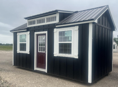 A 10x20 Chalet Shed for sale sitting on a gravel lot.