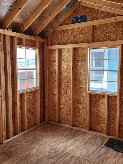 A room with wood flooring and a window, perfect for storing 10x12 Garden Sheds.