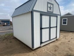 A 10x12 Lofted Barn Shed for sale near me, located in a dirt lot.