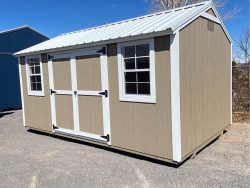 A 10x16 Utility Shed available for sale in a parking lot near me.