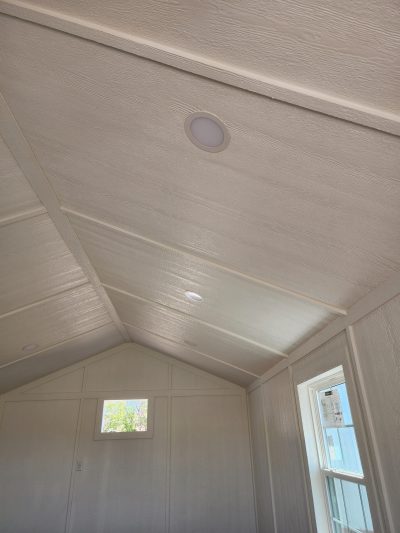 A room with a white ceiling and a window, perfect for those looking for the 12x24 Diamond Cabinette Shed on sale near me.