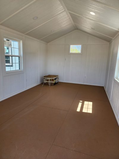 A 12x24 Diamond Cabinette Shed with white walls and tan floors for sale.