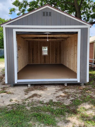 A 12x24 Garage Shed with a door open and a wooden floor available for sale near me.