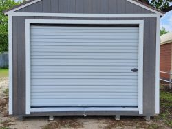 A 12x24 Garage Shed with a white door and a gray roof for sale.