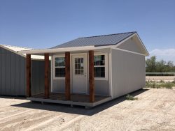 A 12x28 Cottage Shed in the desert with a porch is available for sale near me.