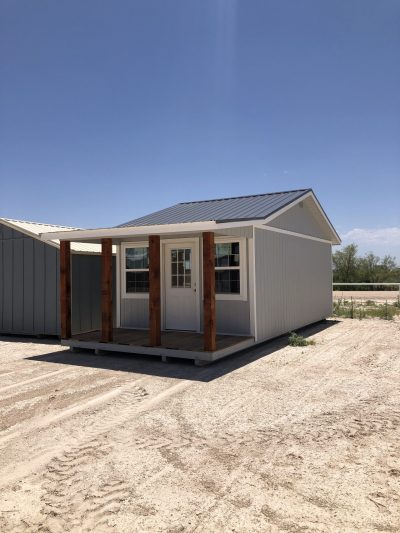 A 12x28 Cottage Shed in the desert with a porch is available for sale near me.