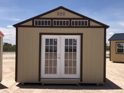 Two 14x20 Utility Sheds on a dirt lot, available for sale.