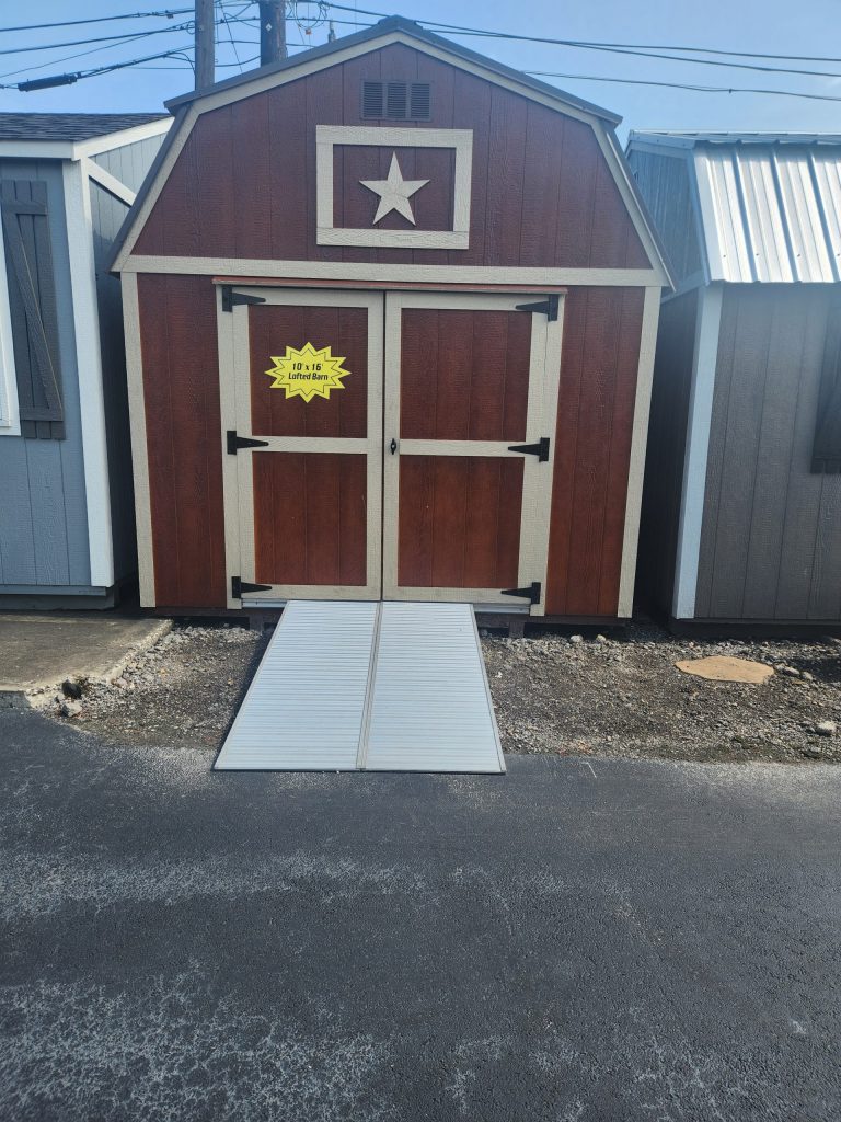  -  - A 10x16 Lofted Barn with a door and a star on it, perfect for sale.