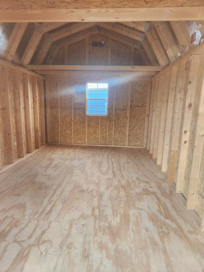 A 10x16 Lofted Barn with wood flooring and a window, available for sale at the nearby shed store.