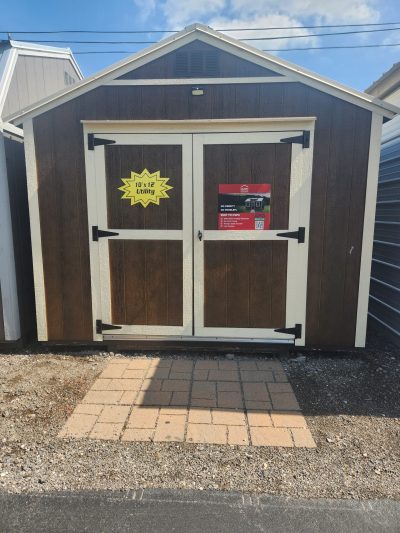 A 10x12 Utility Shed with a sign on it, available for sheds sale near me.