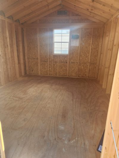 The inside of a 10x12 Utility Shed for sale with wood flooring.