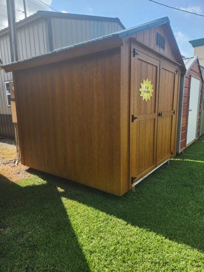 An 8x8 Basic Shed for sale on a grassy area.