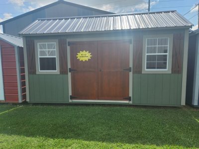 For sale 10x16 Garden Shed: A green and brown shed with a yellow door.