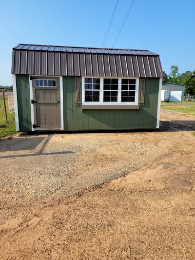 For sale 10x18 Lofted Barn: A green shed with a metal roof available at a sheds store near me.