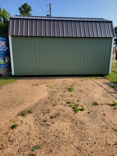 A green 10x18 Lofted Barn with a metal roof available for sheds on sale.