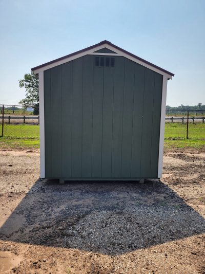 An 8x8 Utility Shed for sale sitting in a dirt field.