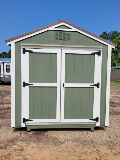 An 8x8 Utility Shed for sale in a parking lot.