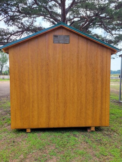 An 8x12 Basic Shed sitting on a grassy area available for sale.