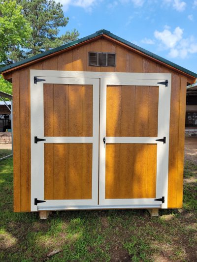 A wooden 8x12 Basic Shed with a white door available for sheds sale near me.