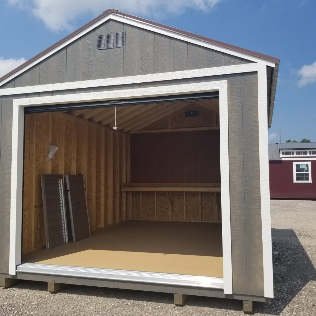  -  - A 12x16 Garage Shed with an open door, available at a nearby shed store on sale.