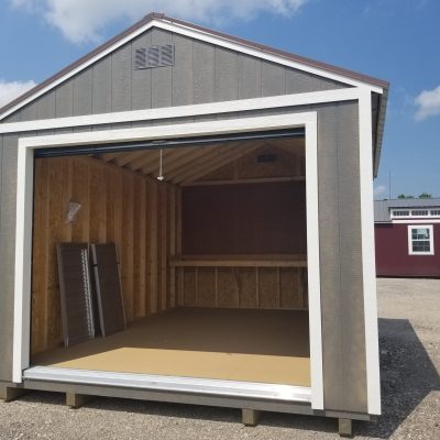 A 12x16 Garage Shed with an open door, available at a nearby shed store on sale.