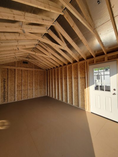 A 12x20 Garage Shed with wood flooring and a door, available for sale.
