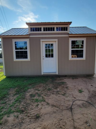 A 12x20 Chalet Shed with a window and a door for sale.