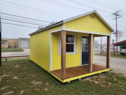 A 12x20 Cabinette Shed with a wooden deck for sale.