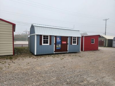 Two 10x20 Lofted Barns for sale in a parking lot.