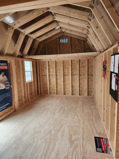 The inside of a 10x20 Lofted Barn with wood flooring available for sale.