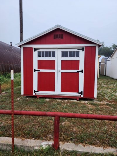 A 10x12 Utility Shed for sale in a field.