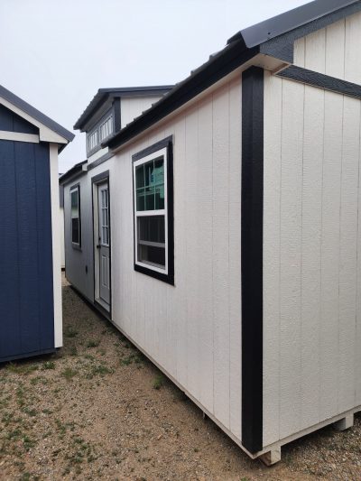 A 12x24 Diamond Chalet Shed with a blue roof and white siding for sale.